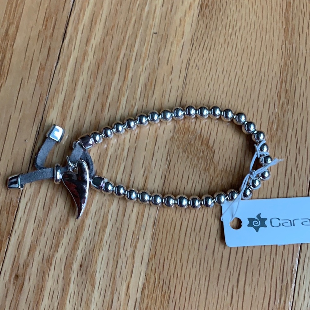 Silver colored beads on bracelet with heart charm.